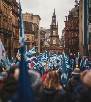 Street in Glasgow full of people with Scottish flags