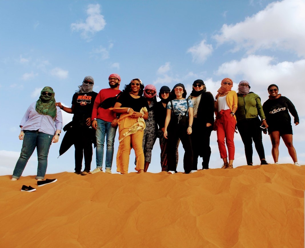 Group of students on sand hill in the desert