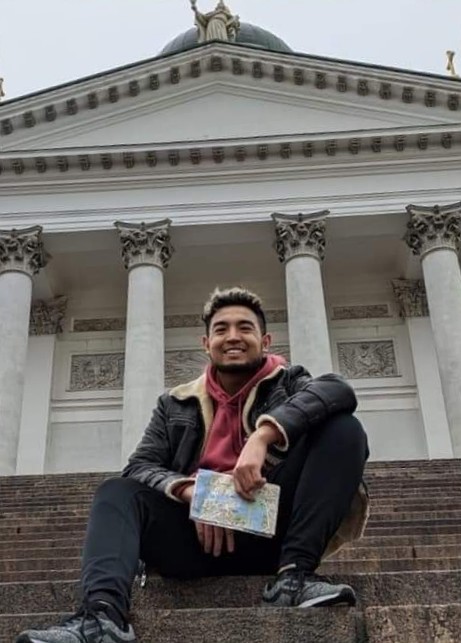 Male student on steps.