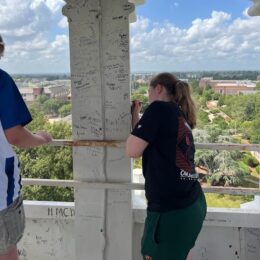 Student signing the tower