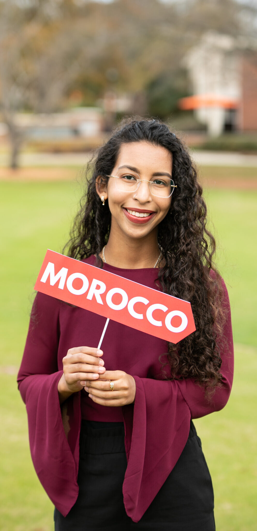 Yasmine Sheik (Gilman recipient) holding a Morocco sign