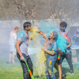 Student throwing colors at Holi