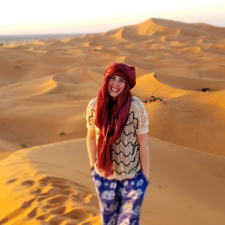 Student in Moroccan desert wearing head scarf