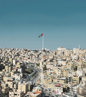 view of Amman cityscape with Jordanian flag